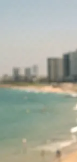 Blurred cityscape and beach with ocean waves under a clear sky.