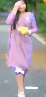 Blurred woman in violet dress walking outdoors.