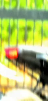 Blurred view of a motorcycle and fence, vibrant colors.