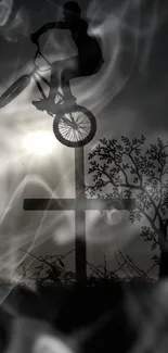 BMX silhouette jumping against evening sky with sun and tree.