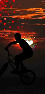 BMX silhouette with hearts against an orange sunset over water.