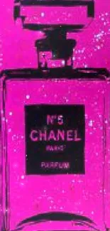 Chanel No 5 perfume bottle on vibrant pink background.