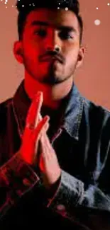 Young man in denim jacket under red lighting