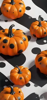 Playful orange pumpkins on a black and white polka dot background.