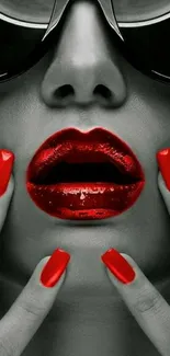 Bold red lips and nails on monochrome background.