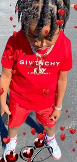 Stylish child in red attire with hearts on a bright background.