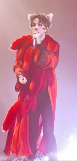 Mobile wallpaper of a performer in a bold red outfit on stage.