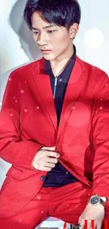 Man wearing a vibrant red suit posing against a white background.