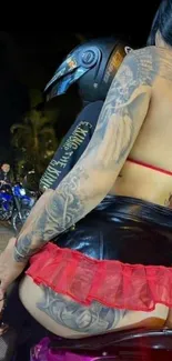 Tattooed woman on a bike at night.