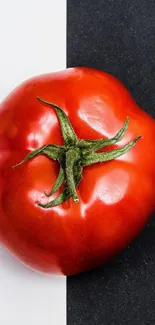 Red tomato on a black and white background, minimalist design.