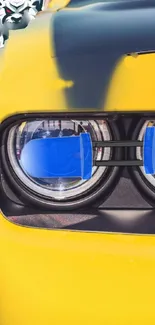 Yellow car headlight close-up mobile wallpaper with modern design accents.