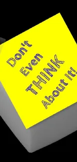 Vibrant yellow sticky note on black background with motivational text.