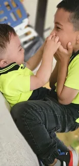 Two kids playing together, smiling brightly.