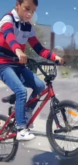 Boy riding a red BMX bicycle under a clear blue sky.