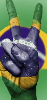 Hand showing peace sign with Brazilian flag colors.