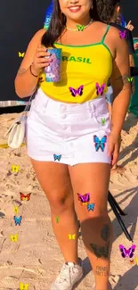 Woman in a bright, vibrant outfit standing on a sunny beach.