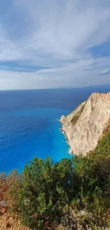 Cliffside view with ocean and sky.