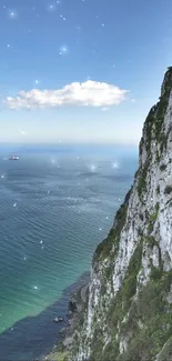 A stunning view of a coastal cliff and ocean under a clear blue sky.