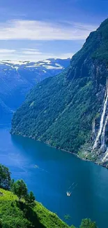 Fjord with waterfall and lush green mountains.