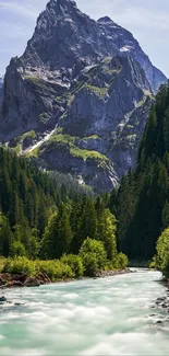 A breathtaking mountain with lush forest and a flowing river under a clear sky.