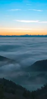 Serene sunrise over misty mountains with a vibrant sky.