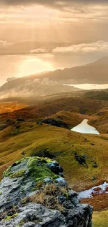 Sunrise over a scenic mountain landscape.