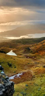 Serene sunrise over a mountain landscape with a golden hue.