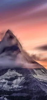 Sunset over a majestic mountain peak with vibrant colors and clouds.