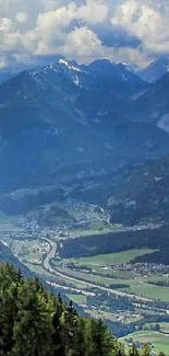 Majestic view of a mountain valley with lush greenery and a winding river.