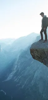 Adventurer stands on mountain edge overlooking stunning landscape.