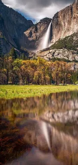 Mountain waterfall reflecting in serene lake.