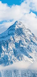 Stunning snowy mountain with blue sky and clouds.