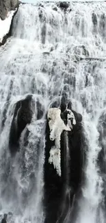 Frozen waterfall cascading over dark rocks.