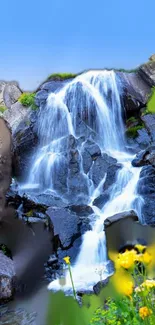 Breathtaking waterfall with rocks and flowers in serene natural setting.