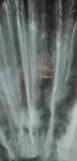 Serene waterfall cascading down rocks in a beautiful natural setting.