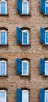 Brick facade with blue shutters, featuring repeated window patterns.