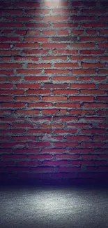 Mobile wallpaper featuring a red brick wall under a spotlight in a dark room.