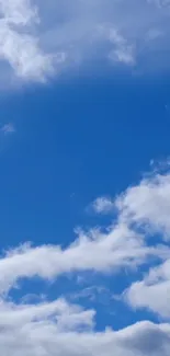 Vibrant blue sky with fluffy white clouds.