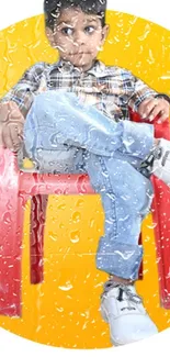 Child on red chair against yellow background, wearing plaid shirt and jeans.