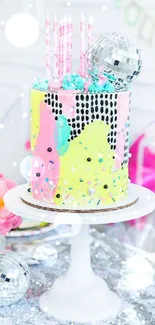 Colorful disco-themed birthday cake with candles on a stand.