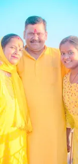 Family in bright yellow under blue sky.