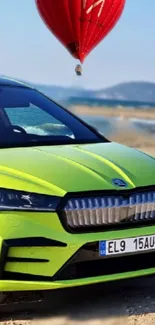 Vibrant green car with hot air balloon on a beach.