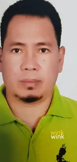 Portrait of a man in a green polo shirt with 'wink wink' text.