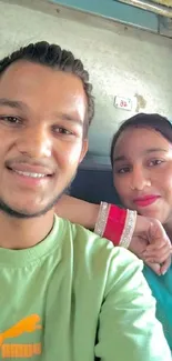 Friends taking a selfie on a train, dressed in bright colors.