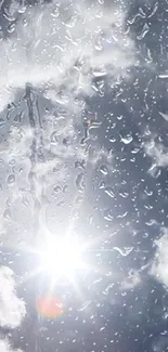 Rain drops on glass with sun shining through clouds.