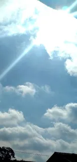 Serene sky with clouds and sunlight rays.