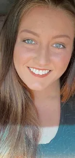 Smiling woman with bright hair in car.