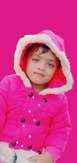 Child in pink winter coat with vibrant background.