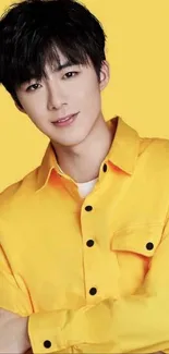 Person in yellow shirt on yellow background, vibrant and stylish.