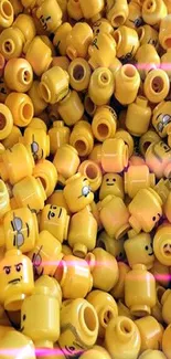 Pile of bright yellow LEGO heads in playful arrangement.